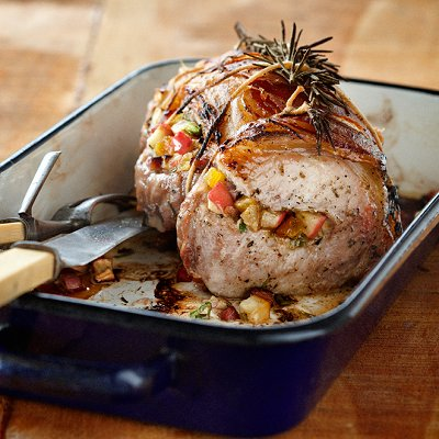 A roast pan filled with a rolled turkey breast stuffed with savoury fruit stuffing.