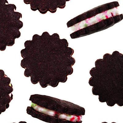 A cascade of Chocolate-peppermint sandwich cookies on a white background.
