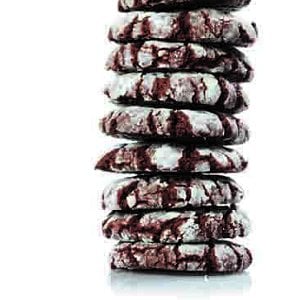 A stack of Flourless chocolate snow mountain cookies on a white background.
