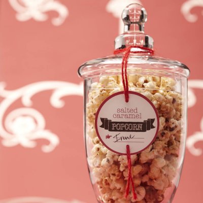A glass jar filled with salted caramel popcorn.