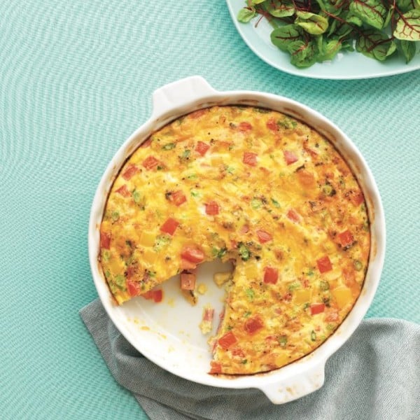 bowl of frittata with a slice taken out