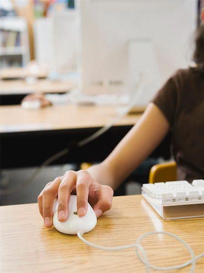 A woman using a mouse on the computer