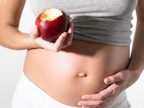 pregnant belly with apple