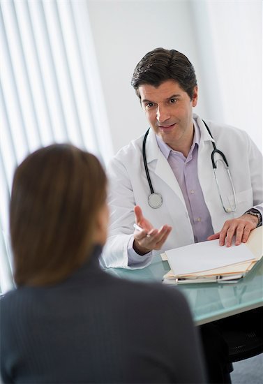 doctor talking to woman patient in office