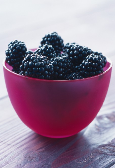 blackberries in pink plastic bowl
