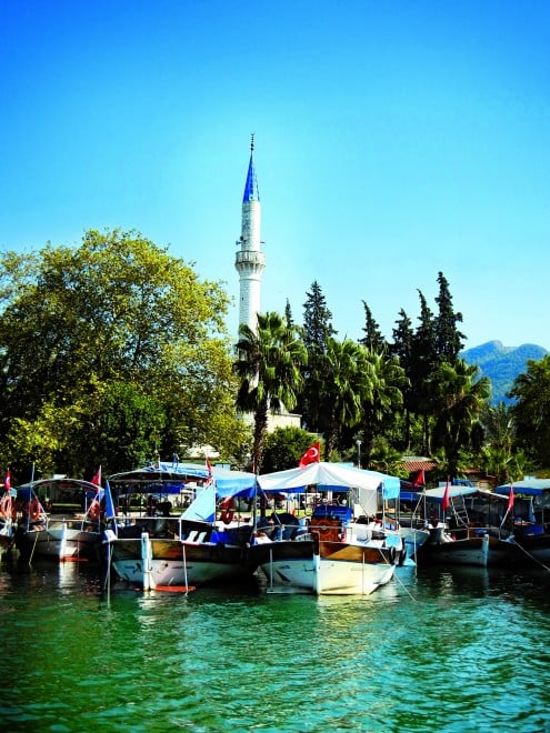 The riverboats and minaret in the village of Dalyan, Turkey