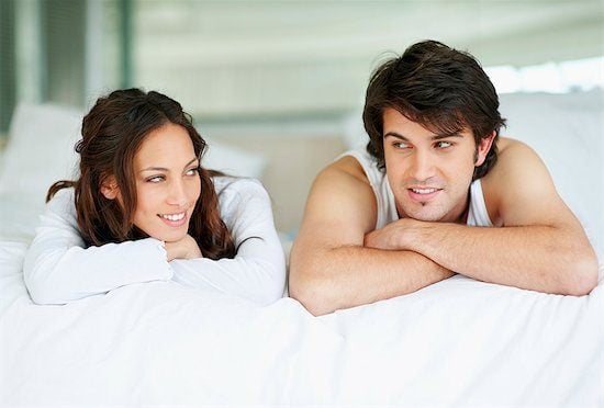 Couple lying on a bed together