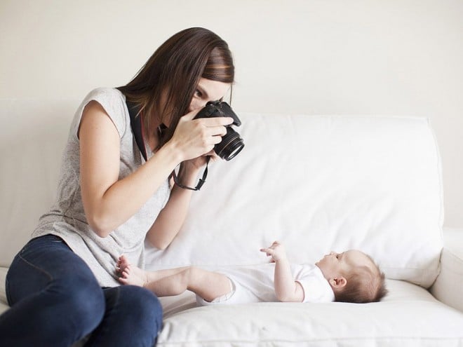 Mother taking photo of her baby