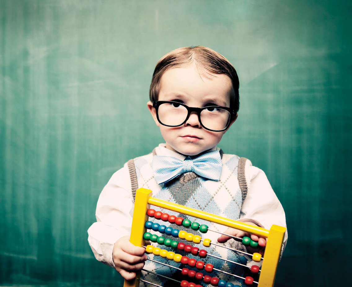 Child in glasses, bow tie, counting toy
