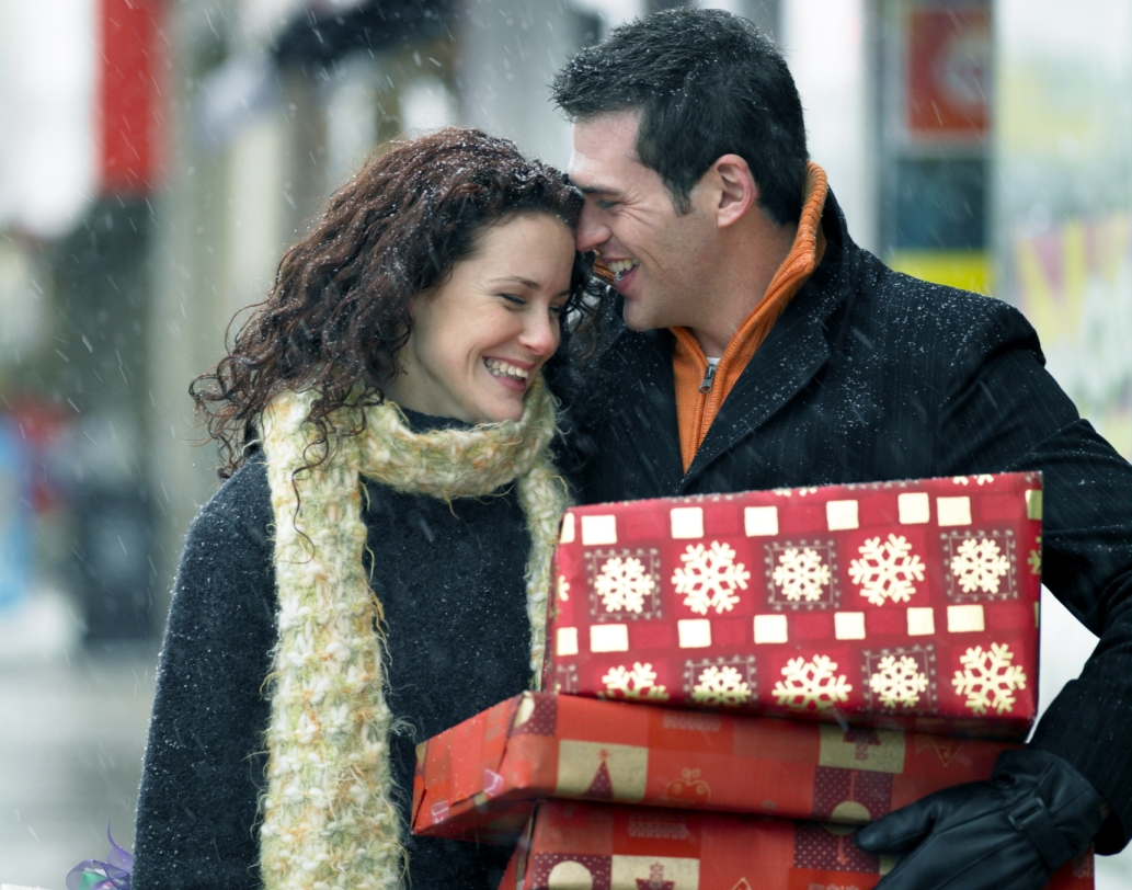 Happy couple with gift for the holidays