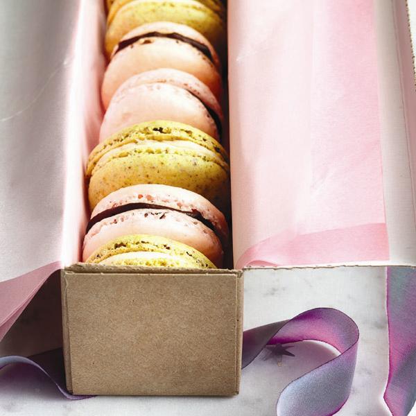 A skinny cardboard box filled with pistachio-cream macarons.