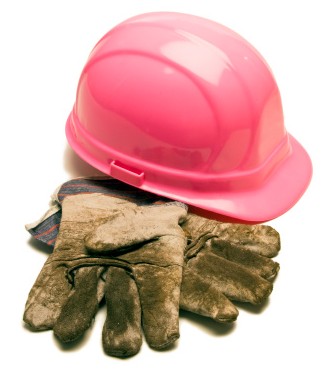 Pink construction hard hat with dirty gloves