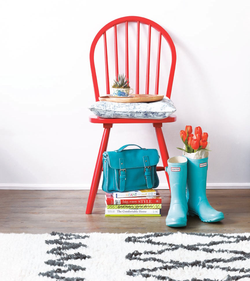 Painted red chair entranceway, Hunter boots, bag and decor books