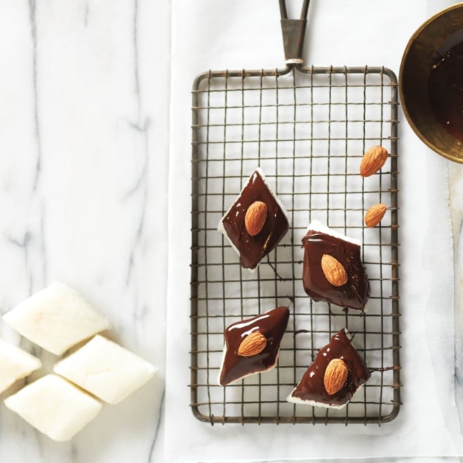 Squares of Chocolate-Coconut Marzipan Bites on a wire rack.