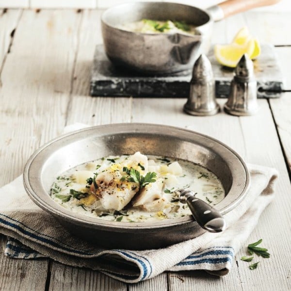 leek and fennel soup with poached haddock recipe in tin bowl on wooden tabletop
