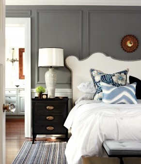 calming bedroom white headboard grey wall black nightstand