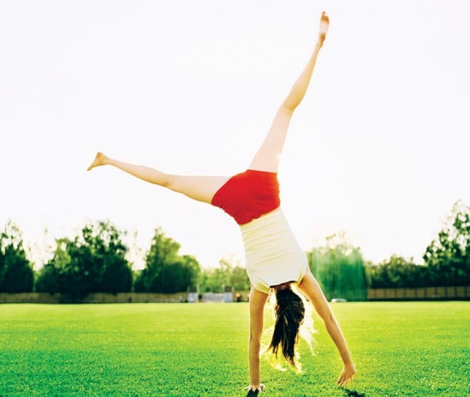 Happy Woman doing a Cartwheel in the park