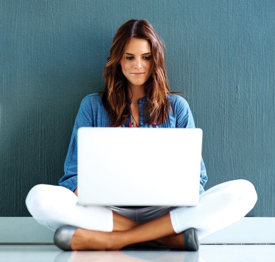 woman on laptop sitting on floor