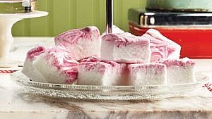 Peppermint sparkle homemade marshmallows on a glass serving plate on a white marble counter