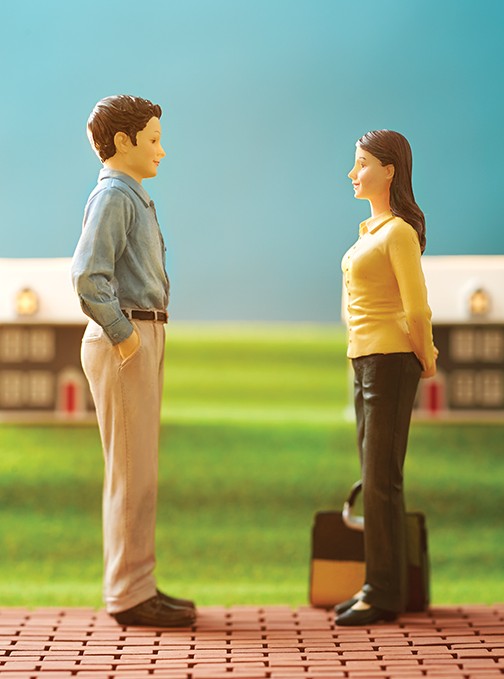 Parent toy miniature figurines standing with a briefcase, about to move and divorce