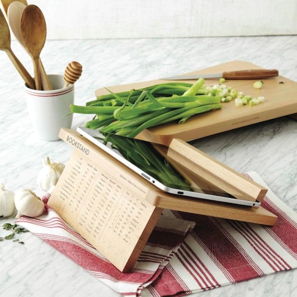 Cutting board, recipe holder and chopped vegetables