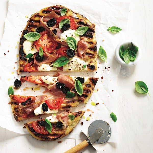 Easy dinner recipes: Grilled pizza on parchment with rolling pizza cutter