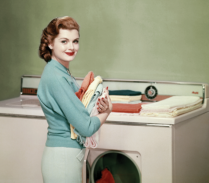 woman doing laundry, folding clothes