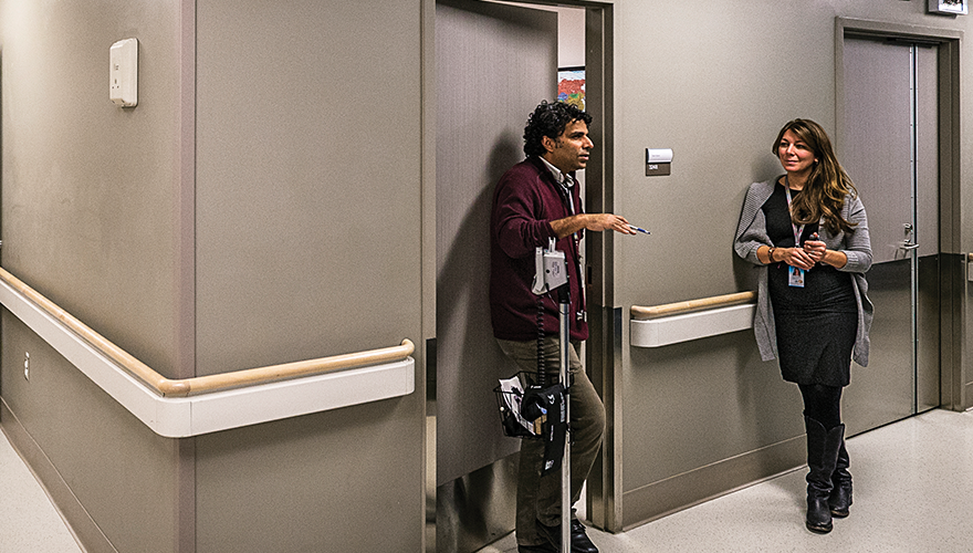 Dr. Meb Rashid speaks with nurse practitioner Vanessa Wright in the hallway of the Crossroads Clinic at Toronto’s Women’s College Hospital.