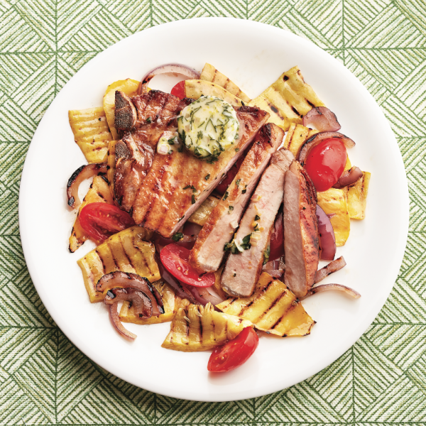Grilled pork chops with basil butter and grilled vegetables