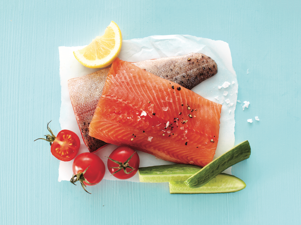 Freezer storage: Fresh piece of trout with cucumbers, tomatoes and lemon