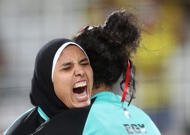 Egypt's Doaa Elghobashy, left, hugs her teammate Nada Meawad, right, during a women's beach volleyball match against Germany at the 2016 Summer Olympics in Rio de Janeiro, Brazil, Sunday, Aug. 7, 2016. (AP Photo/Petr David Josek)