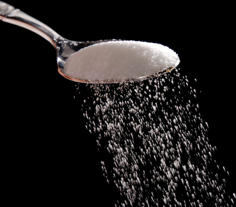 Granulated sugar is poured in Philadelphia, Monday, Sept. 12, 2016. A new study released Monday details how the sugar industry worked to downplay emerging science linking sugar and heart disease. It's the latest installment of an ongoing project by a former dentist to reveal the industry's decades-long attempt to influence science. The Sugar Association said it questions the author's attempt to play into current anti-sugar sentiment. (AP Photo/Matt Rourke)