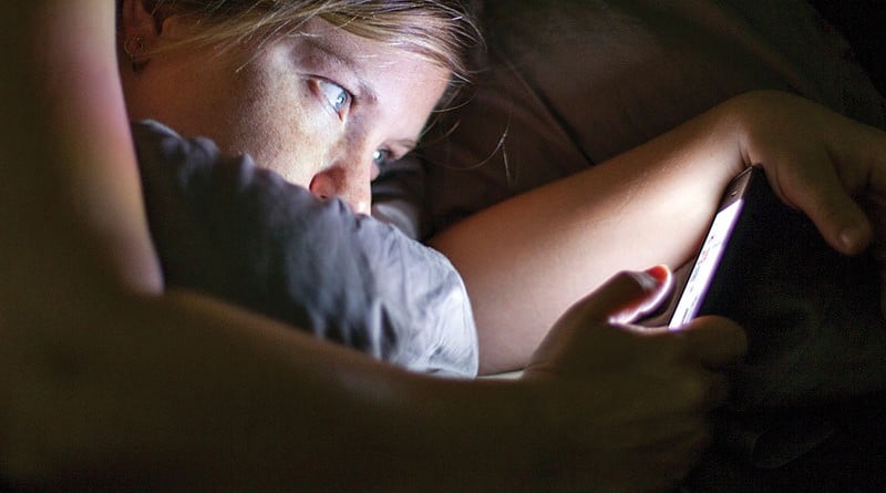 Image of woman looking at her for as the display image for the article on Social media and mental health
