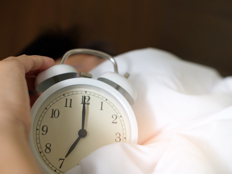 better sleep-alarm clock sitting on white sheets