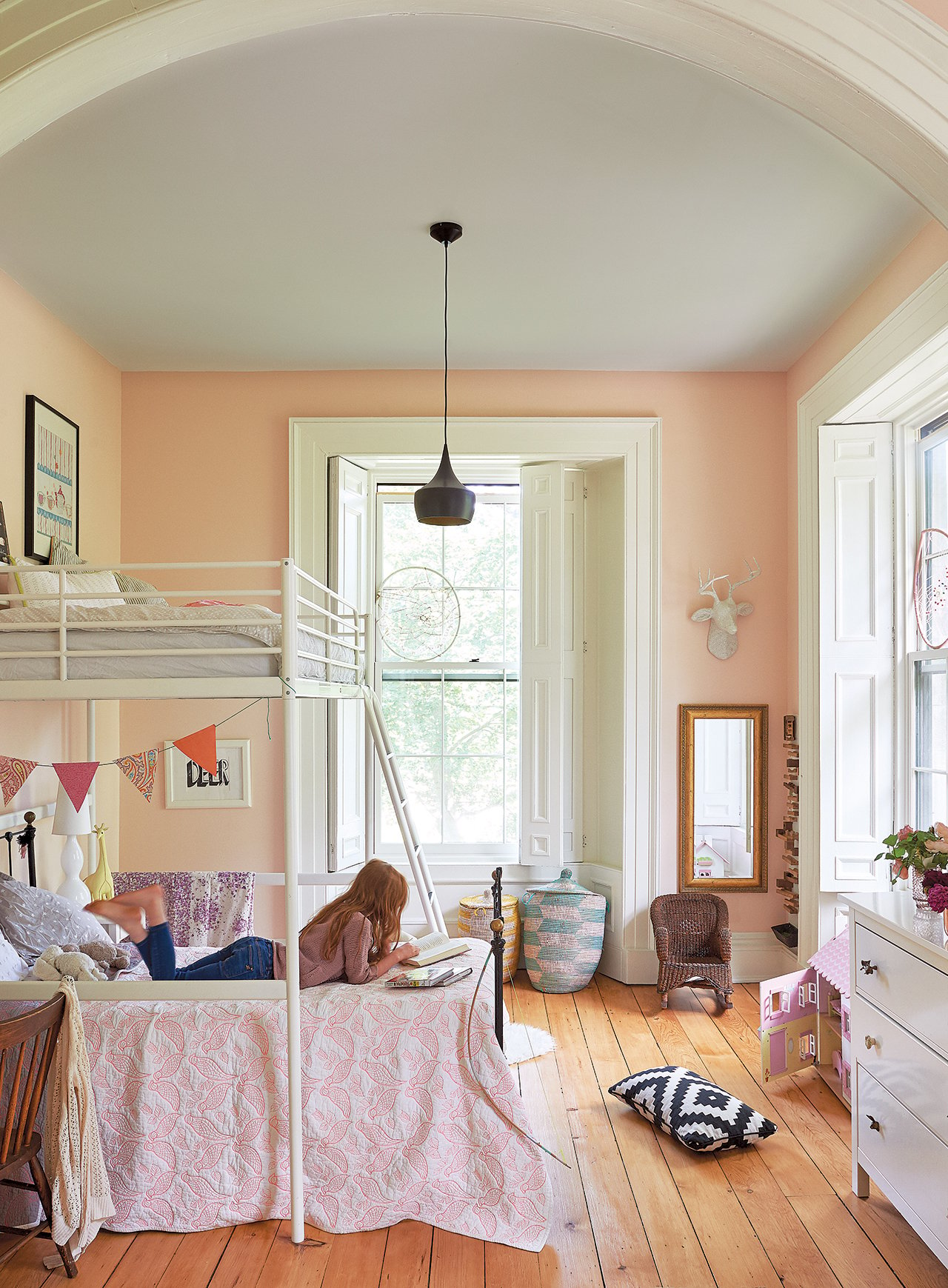 The daughter's bedroom has light neutral walls, wooden floors, big windows, and a beautiful bunk bed.