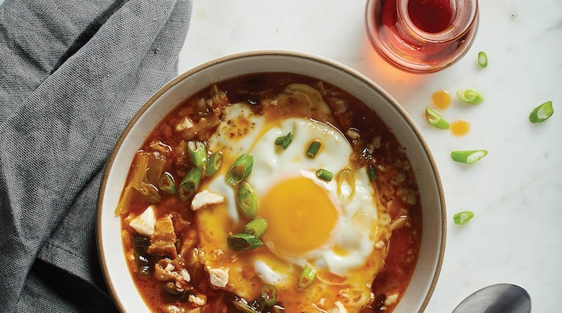 Instant pot stew: Bowl of Korean-style stew topped with egg next to grey napkin