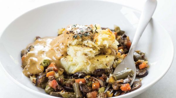 White bowl filled with Oh She Glows vegan shepherd's pie