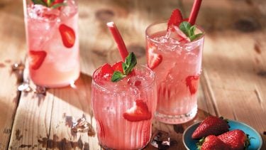 Strawberry-rhubarb-sangria in clear glasses on wooden tabletop