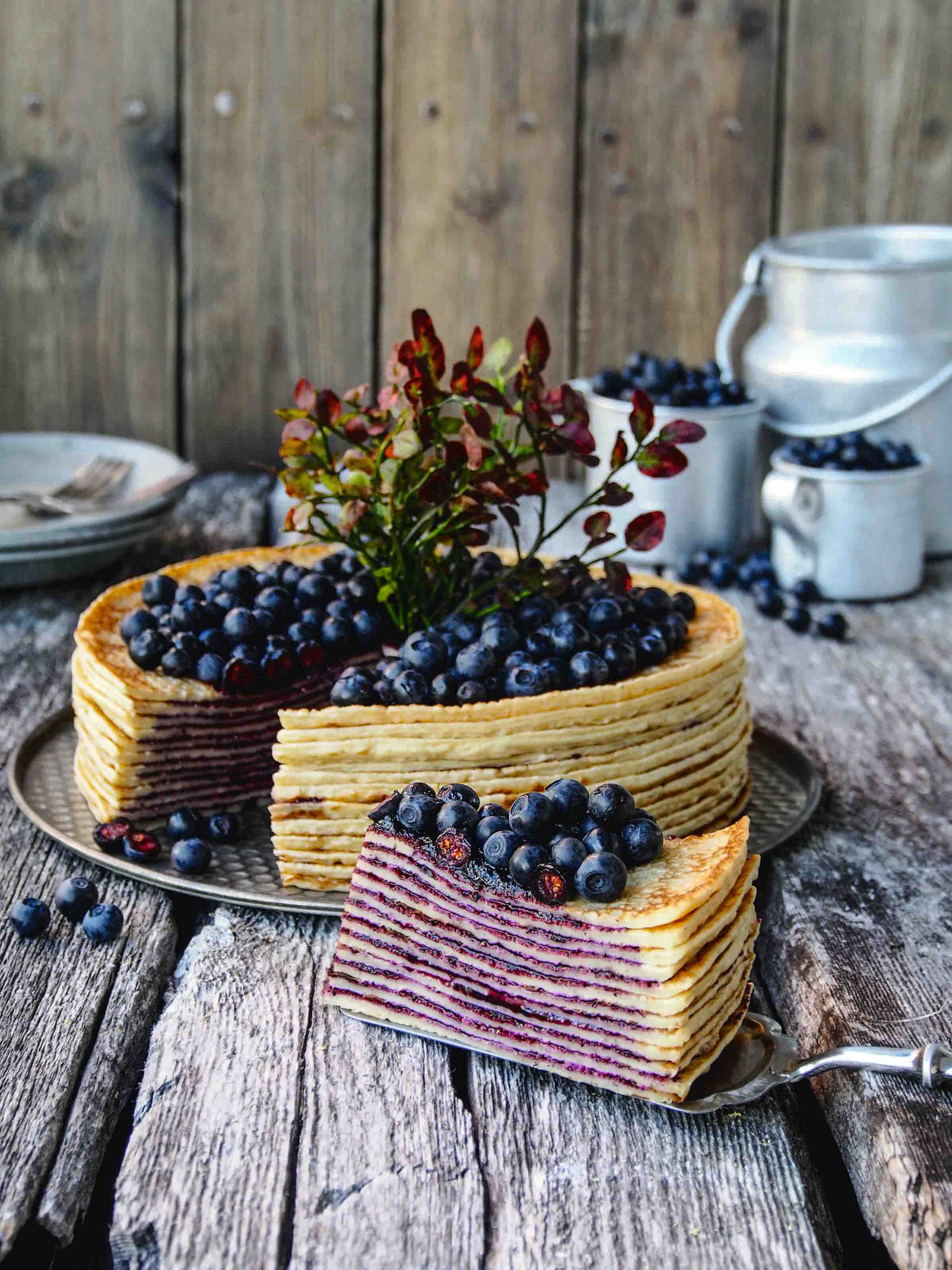 Crepe cake topped with blueberries.
