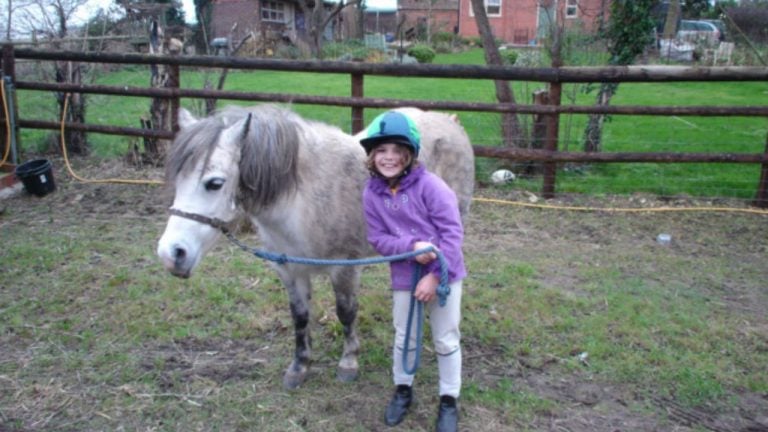 Only child died-Inida standing with her favourite Pony.