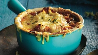 Slow cooker French onion soup in blue bowl