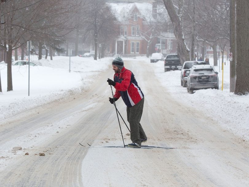 A man skis on the street in Kingston, Ontario. The extreme cold is tied to a polar vortex; climate change makes extreme weather more likely