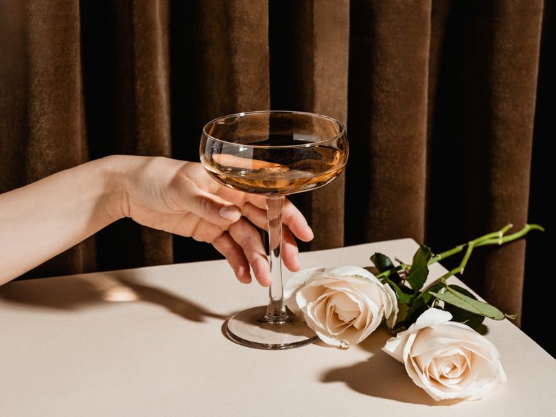 A woman reaches for a cocktail. Women are increasingly drinking themselves into long-term illness and even death