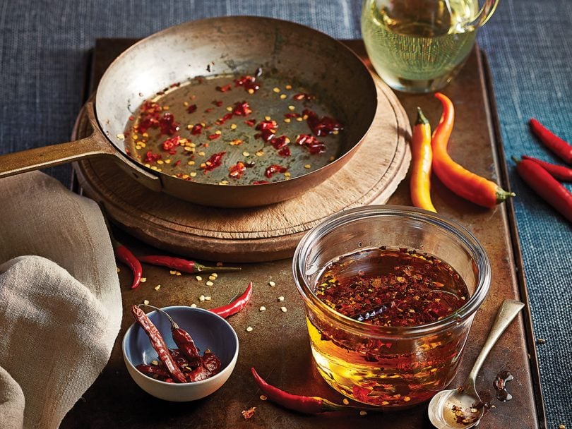 Hot red chili oil in pan and jar