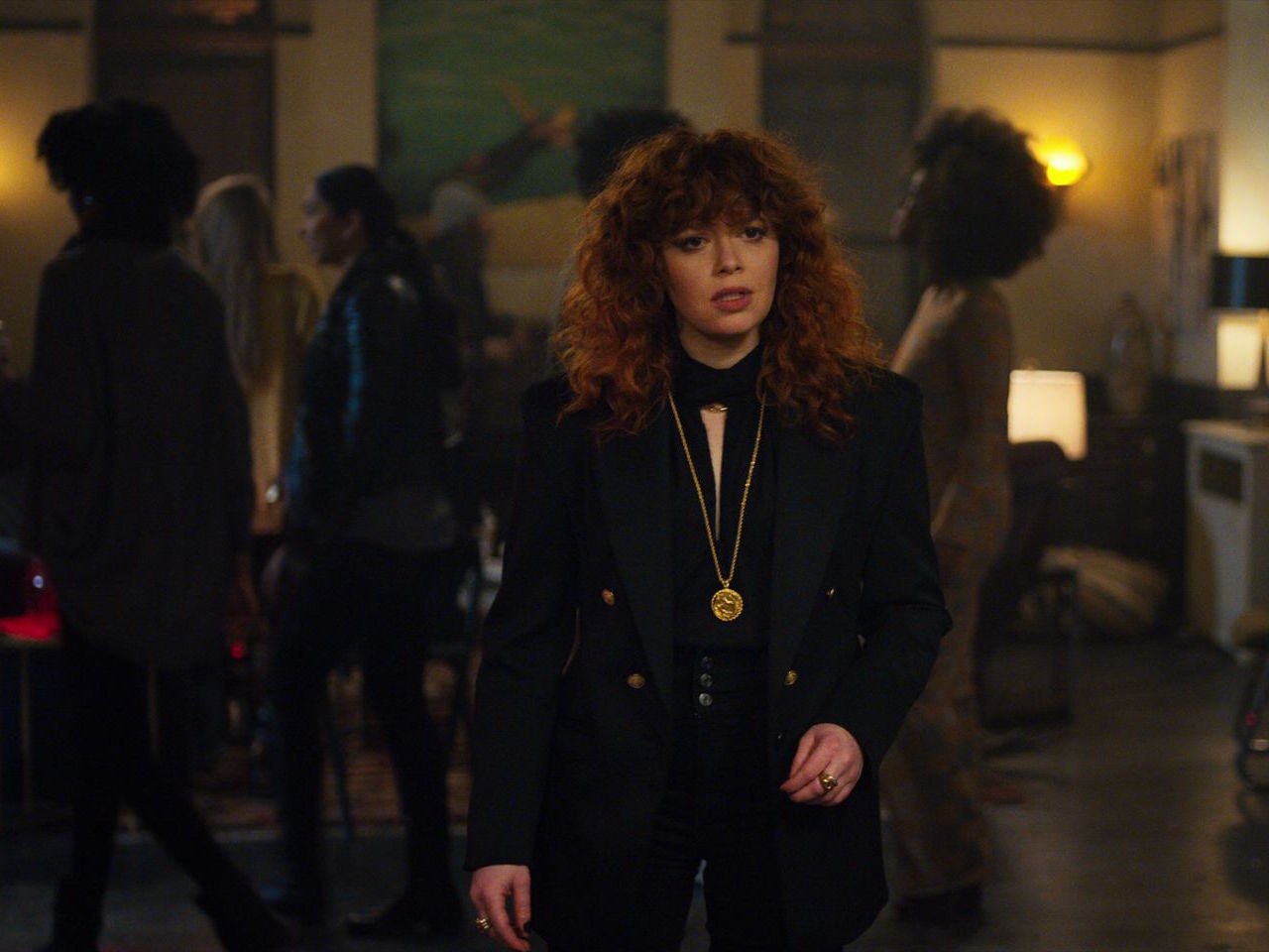Netflix Russian Doll - a still from Netflix's Russian Doll shows Natasha Lyonne looking upset as she stands in a living room full of people