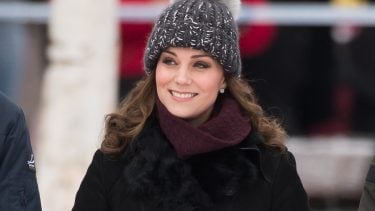 Kate Middleton Pieces feature image shows Kate wearing a pom-pom toque and a black jacket