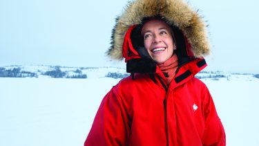 Courtney Howard in red parka against snow covered background — Courtney Howard climate change mental health