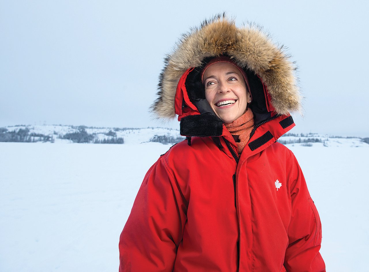 Courtney Howard in red parka against snow covered background — Courtney Howard climate change mental health