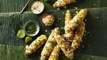 Corn recipes: Overhead shot of A few cobs of Filipino Grilled Corn on a green leafy background