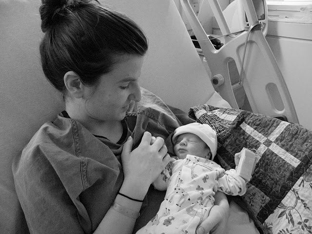 The writer holds her newborn in hospital